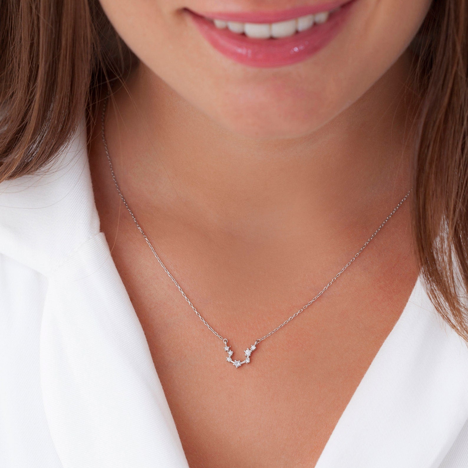 Zodiac constellation jewelry styled in layers