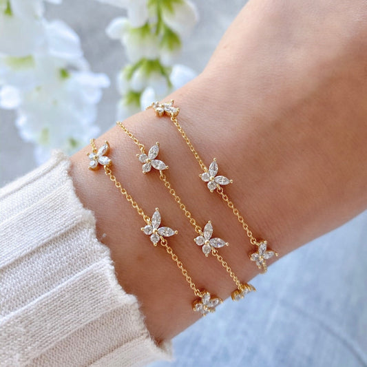 Dainty gold butterfly bracelet with white crystals – front view