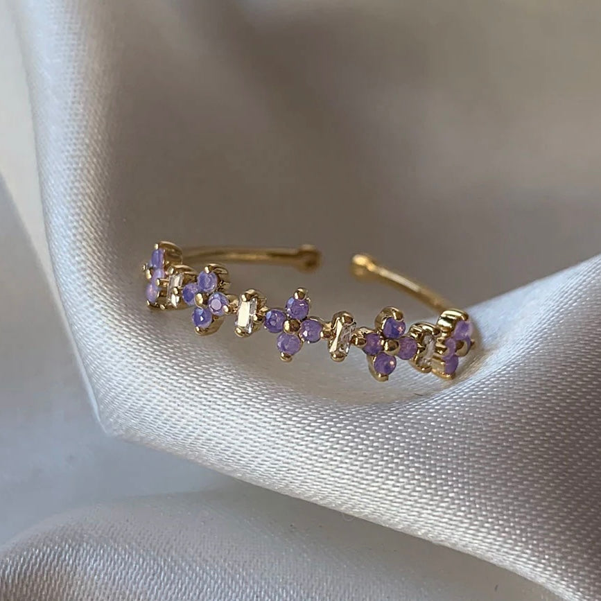 Dainty gold ring with purple flower crystals – front view