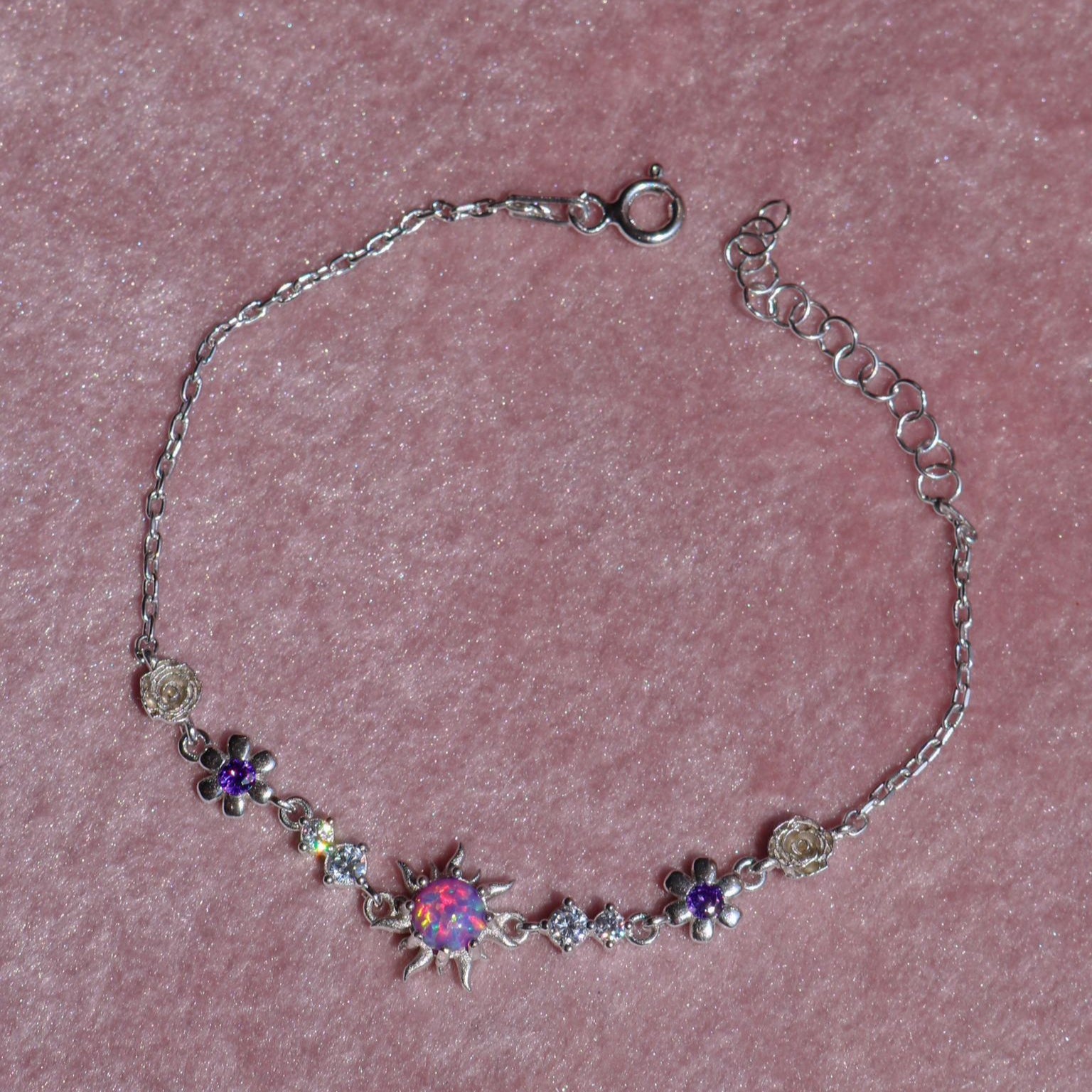 Delicate silver bracelet with glowing opal charm
