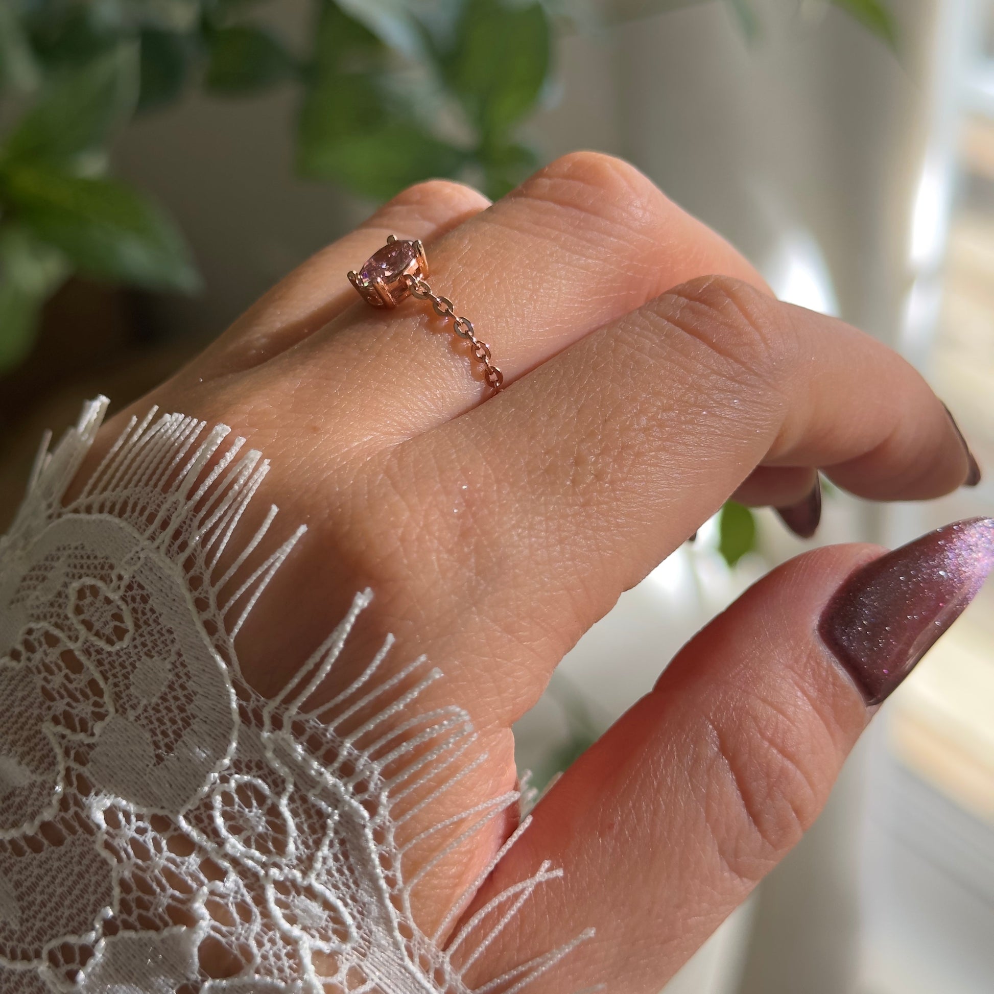 Close-up of dusty pink zirconia on adjustable chain ring