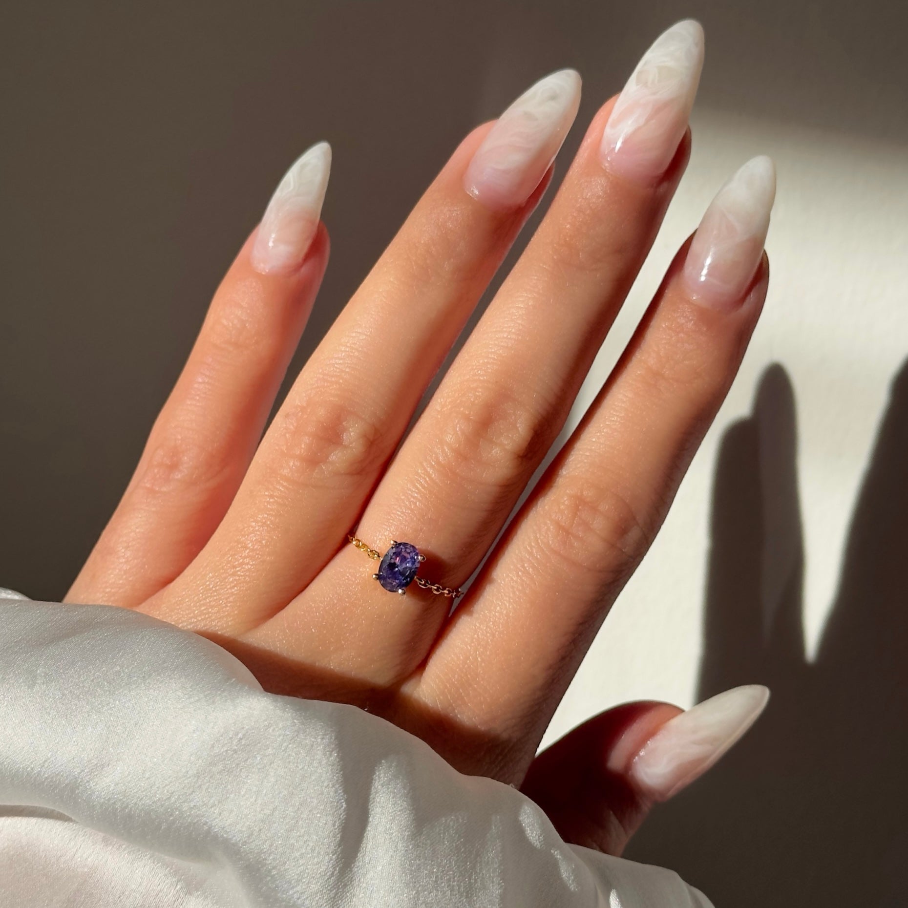 Detail view of Tanzanite Blue stone on gold chain ring
