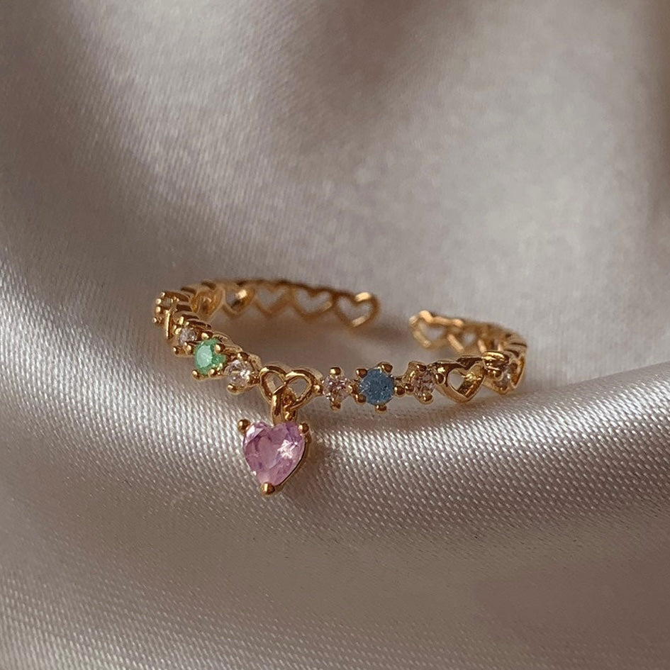 Close-up of adjustable heart charm ring with crystals