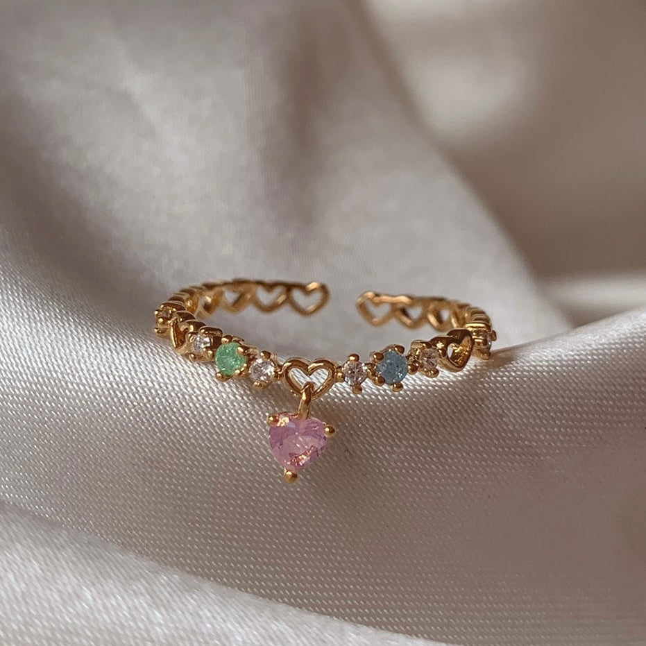 Heart charm ring worn on hand – delicate and romantic