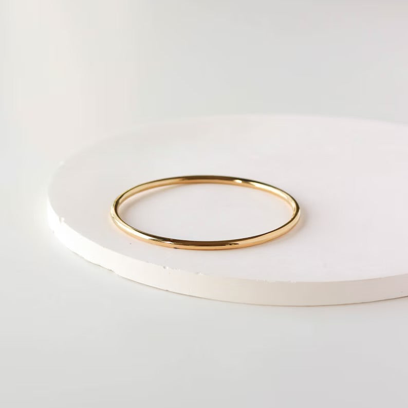 Minimalist bracelet stacked with other bangles