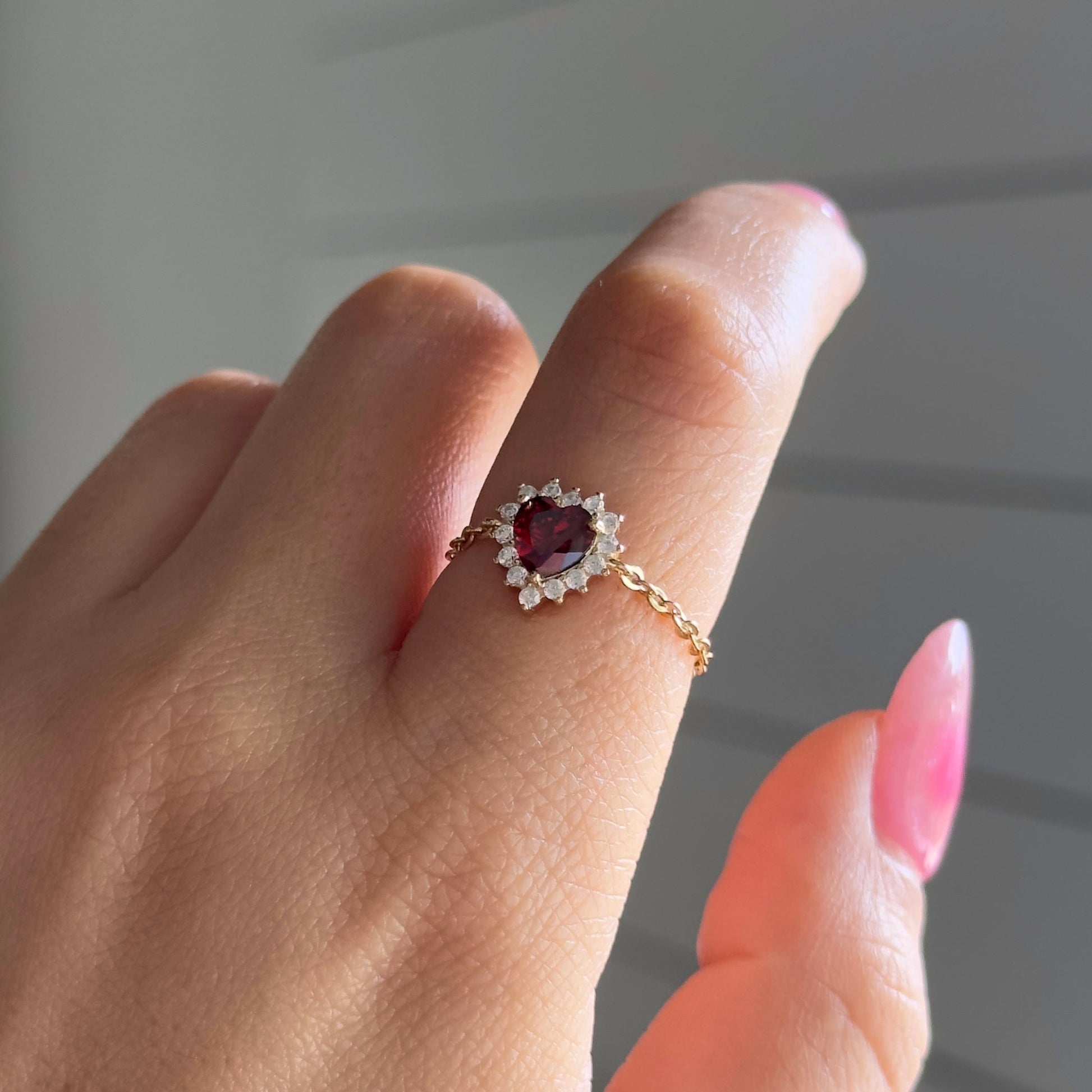 Model wearing Queen of Hearts chain ring with red heart