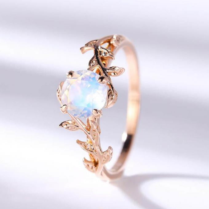 Close-up of moonstone ring with embedded crystals