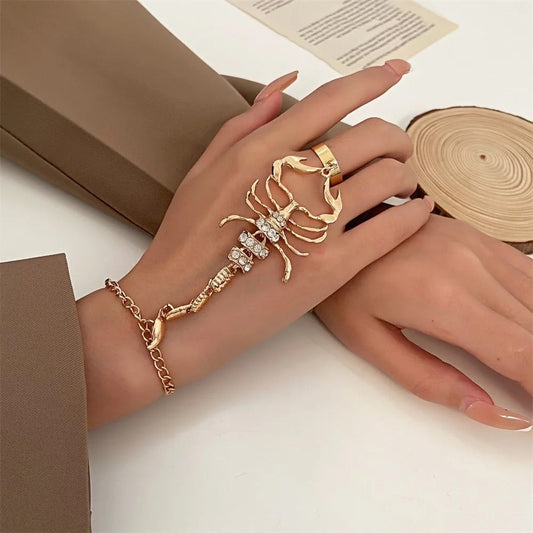 Front view of gold scorpion bracelet with zircon crystals