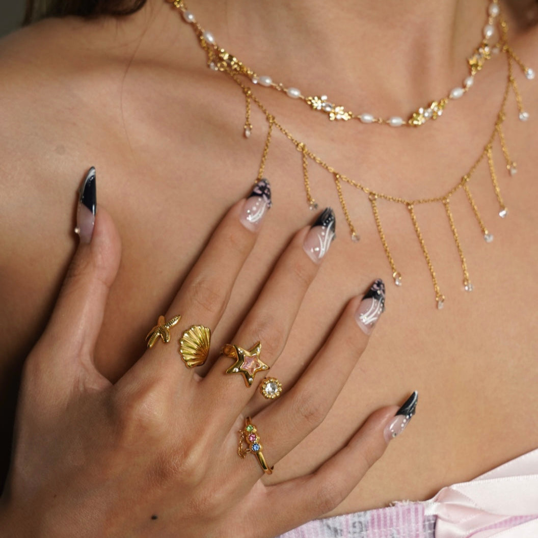 Shell ring stacked with other summer jewelry pieces