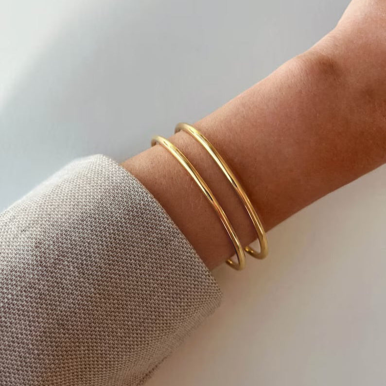 Silver minimalist bangle styled on wrist